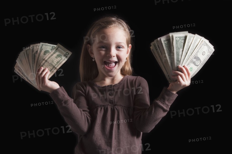 Young girl holding money. Photographer: Mike Kemp