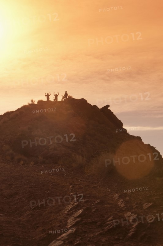 Mountain bikers on mountain peak. Photographer: Dan Bannister