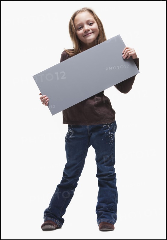 Young girl holding blank sign. Photographer: Mike Kemp