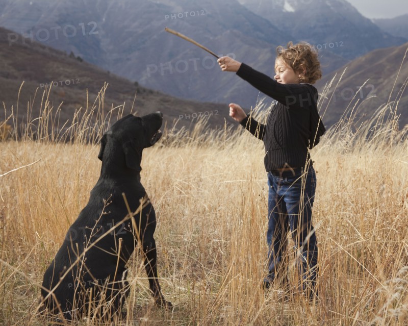 Girl playing fetch with dog. Photographer: Mike Kemp