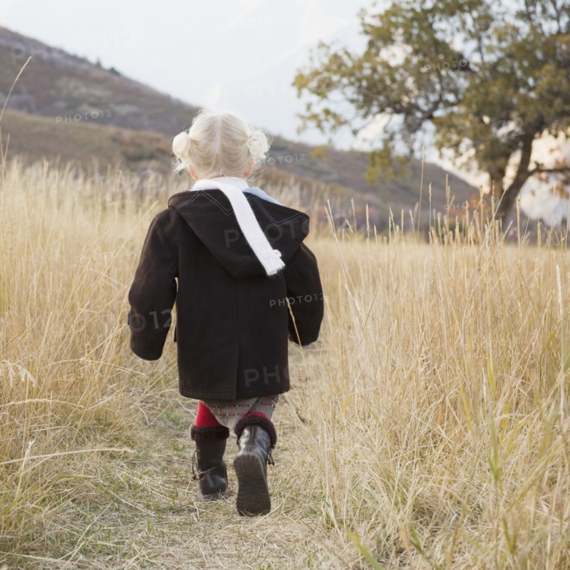 Girl walking in a meadow. Photographer: Mike Kemp