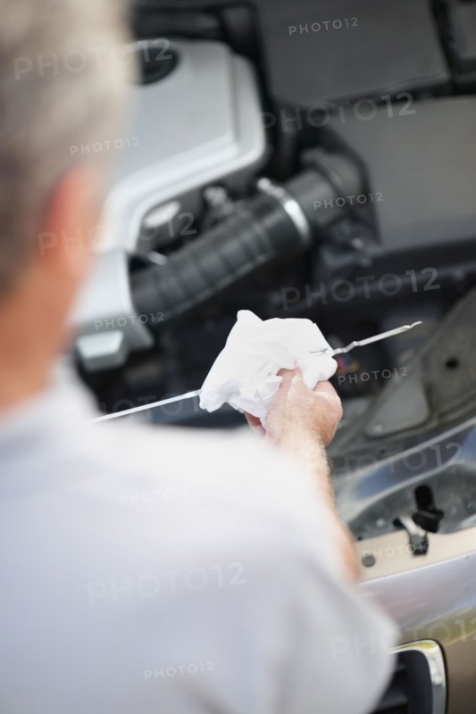 Checking the oil. Photographer: momentimages