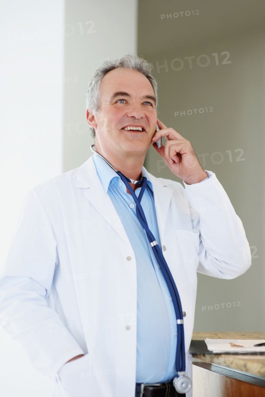 Doctor talking on phone. Photographer: momentimages