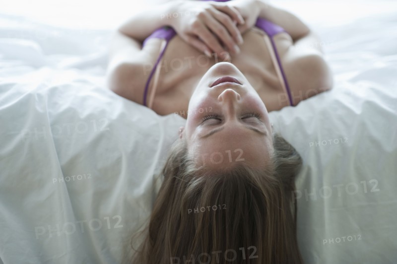 Woman lying on bed.
