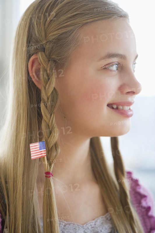 Young girl with American flag in hair.