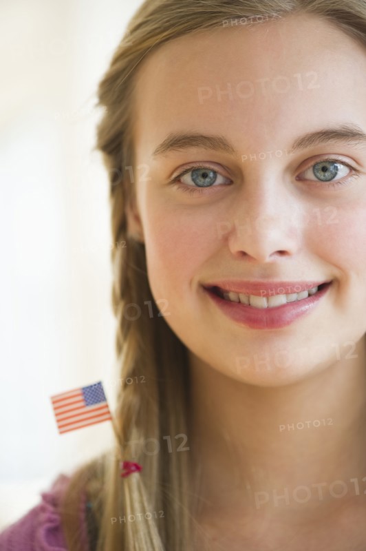 Young girl with American flag in hair.