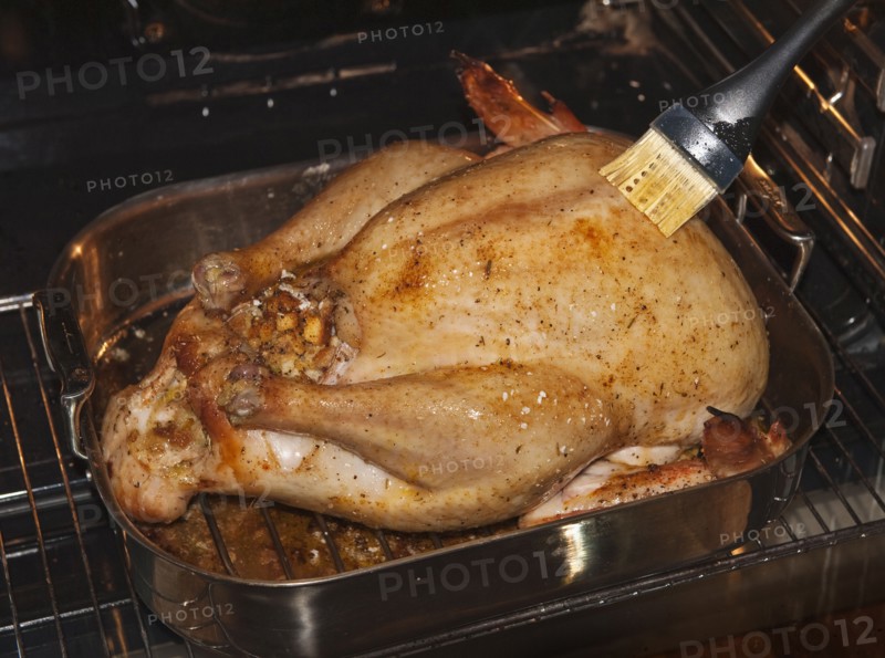 Basting a turkey.