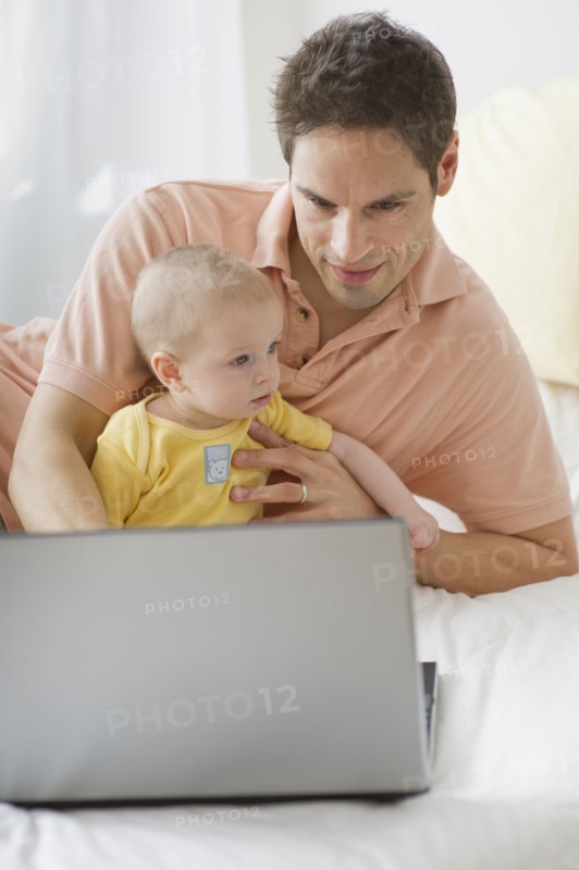 Father working on laptop.