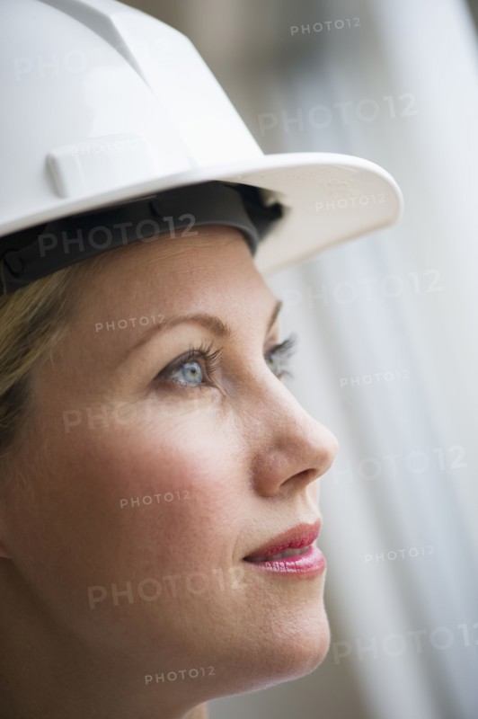 Female architect wearing a hard hat.