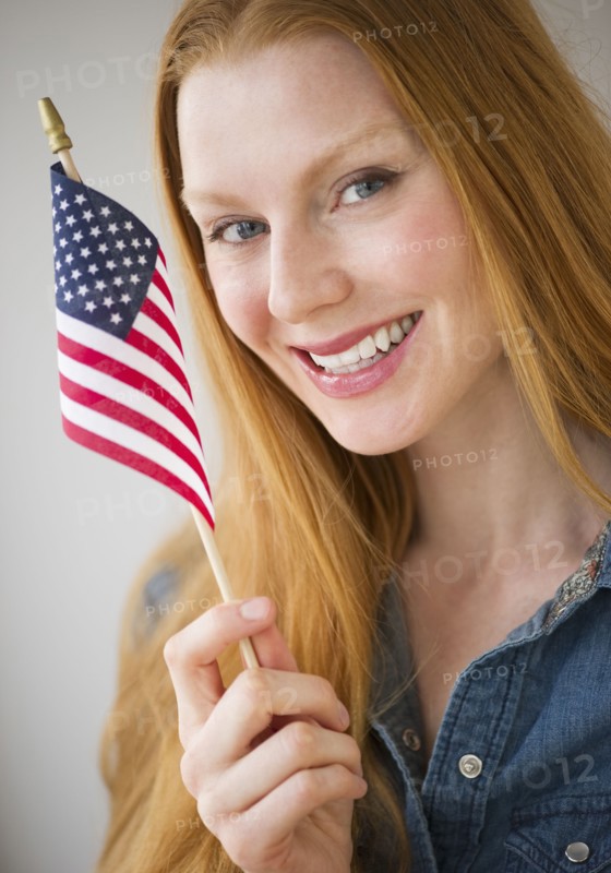 Woman holding American flag.