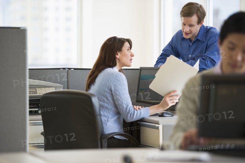 Office workers in cubicles.