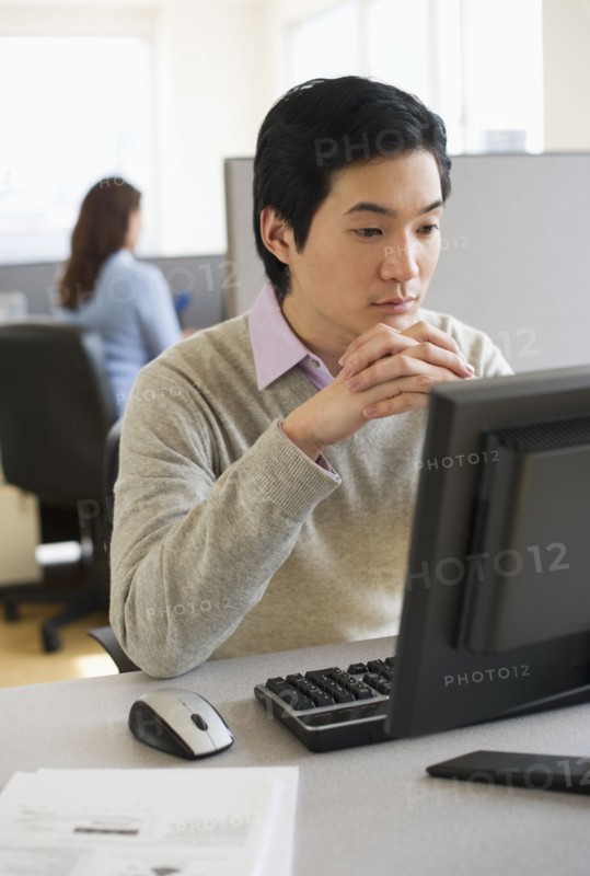 Man working in cubicle.