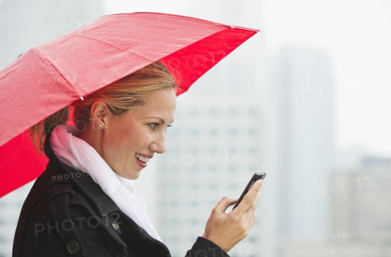 Woman texting on a rainy day.