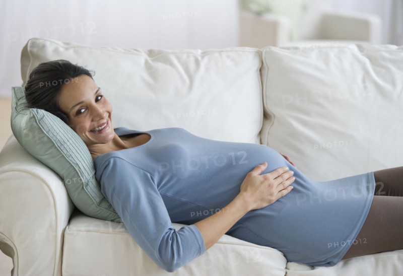 Pregnant woman resting on couch.