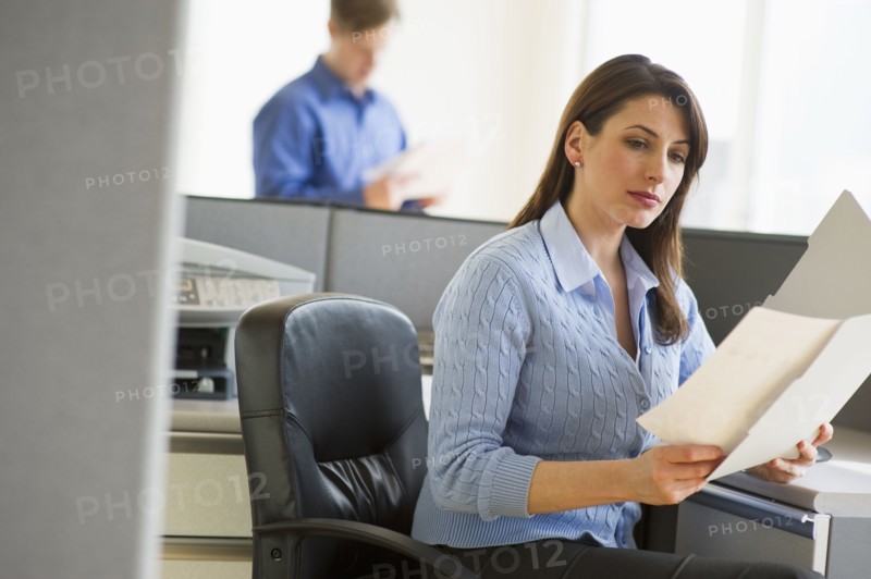 Woman working in cubicle.