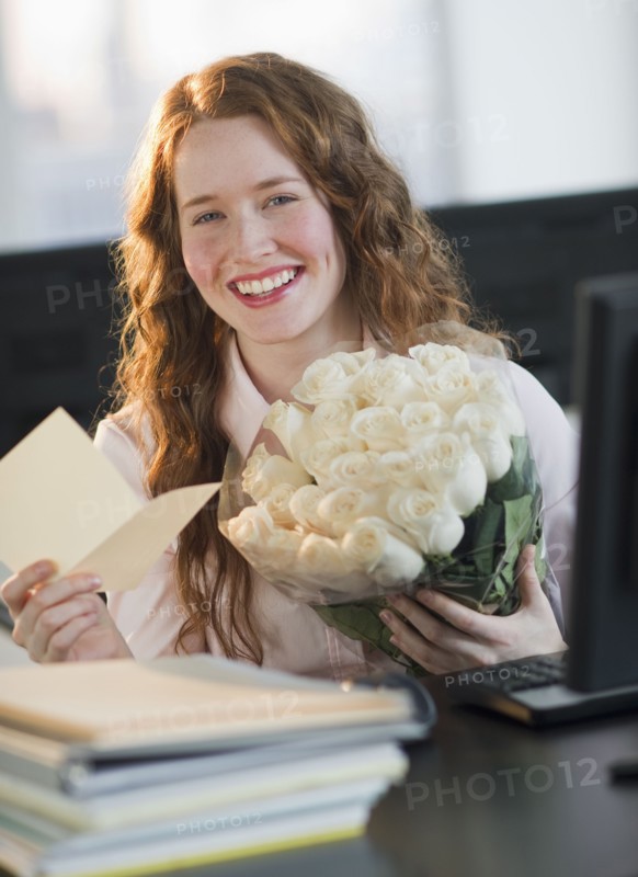 Woman holding bouquet of flowers.