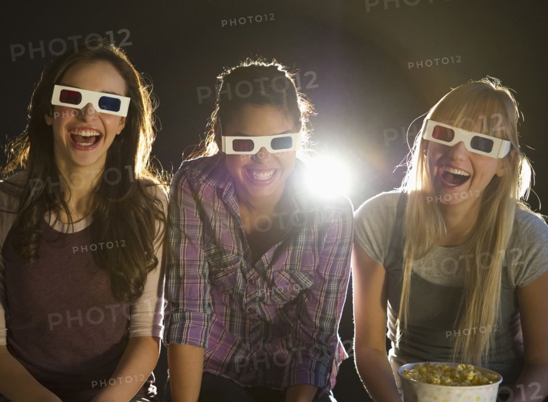 Young girls watching 3D movie.