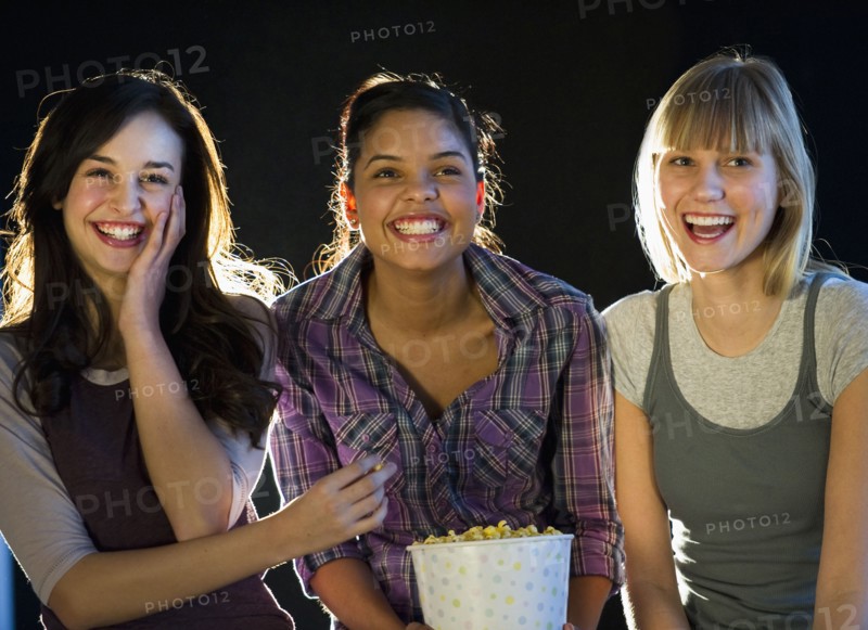 Young girls eating popcorn.