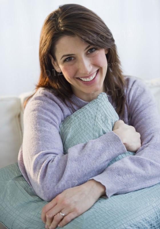 Woman hugging a pillow.