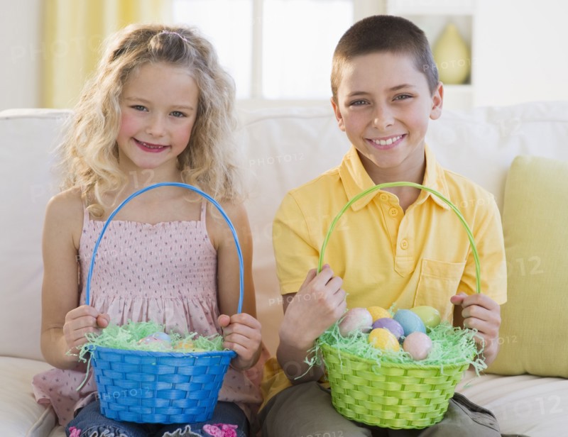 Young children holding Easter baskets.