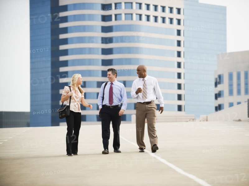 Co-workers walking in parking lot.