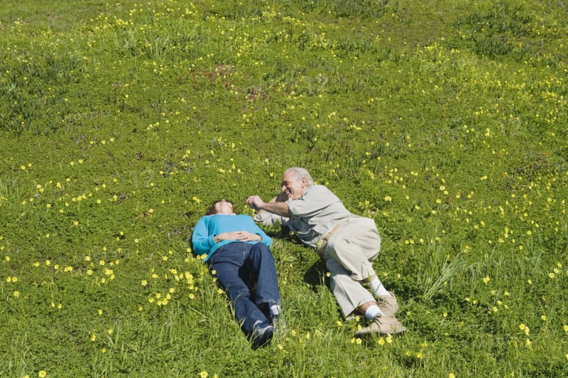 Couple relaxing in meadow.