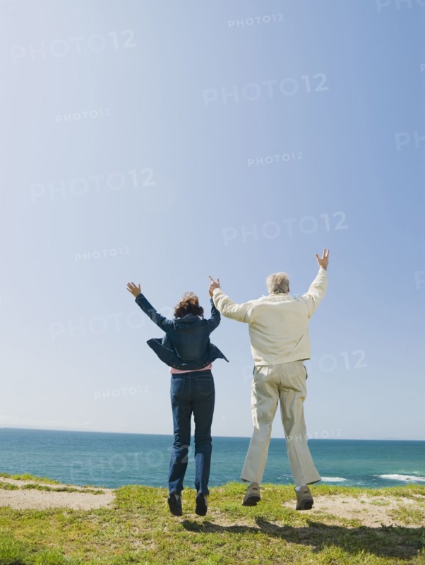 Couple jumping.