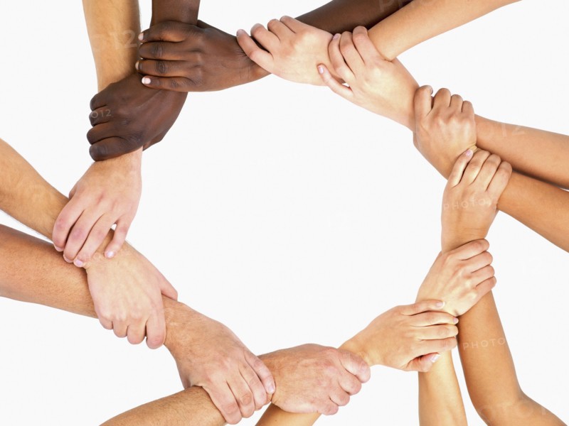 Clasped hands in a circle. Photographe : momentimages