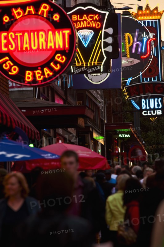 Crowd of people and Illuminated signs on Beale Street.