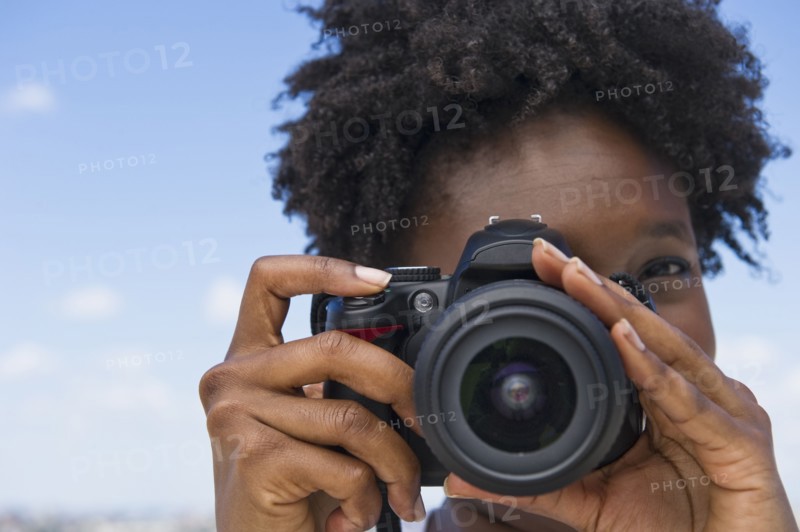 Woman taking picture with a digital camera.