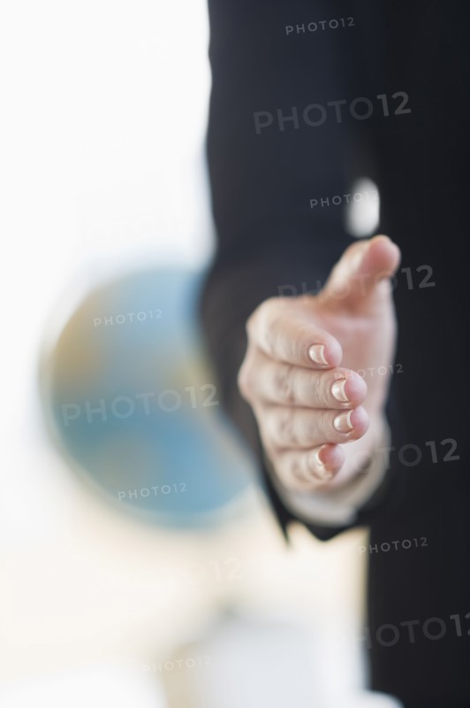 Hand extended for handshake.