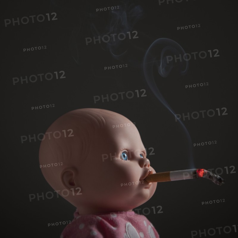 Cigarette in doll's mouth. Photo : Mike Kemp
