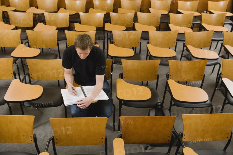 Last student left in college lecture hall.