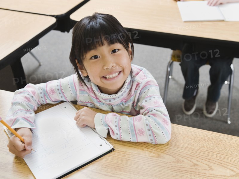 Elementary student writing in her notebook.