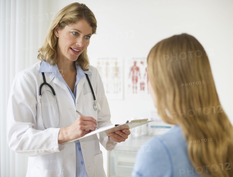 Doctor talking to patient in exam room.