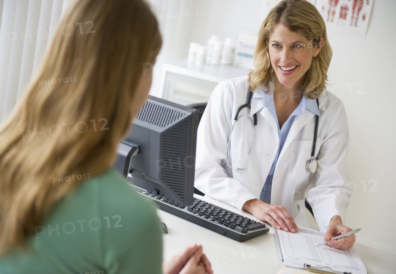 Medical consultation in exam room.