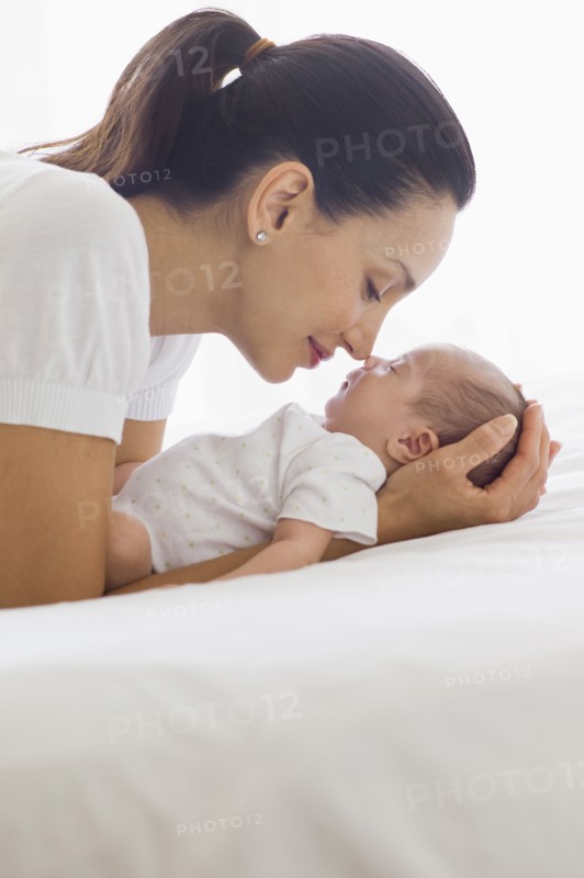 Mother holding her sleeping baby.