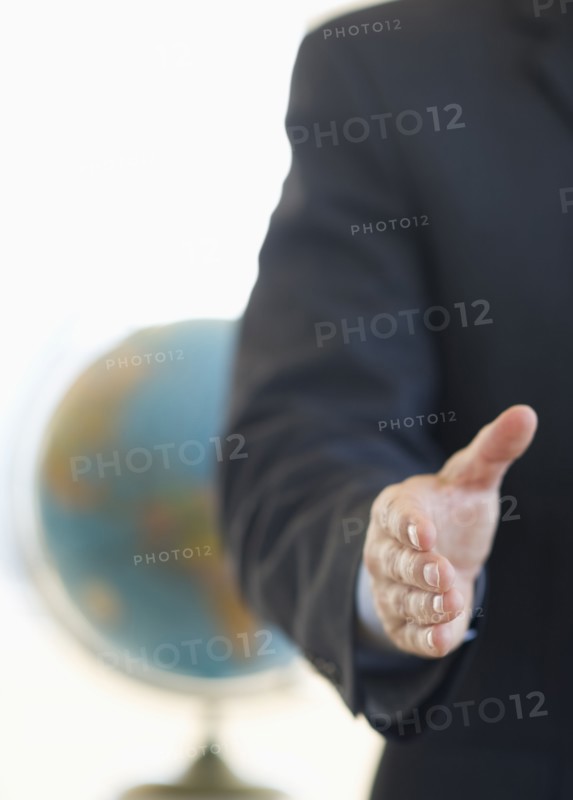 Hand extended for handshake.