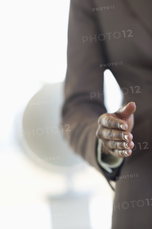 Hand extended for handshake.