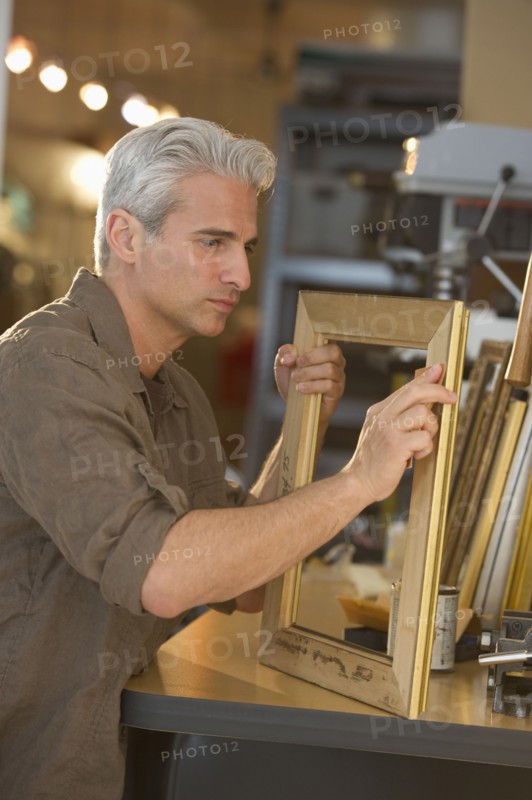 Craftsman making a picture frame.