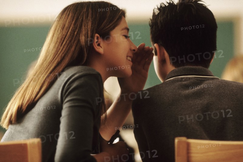 Students whispering in class. Photo : Rob Lewine
