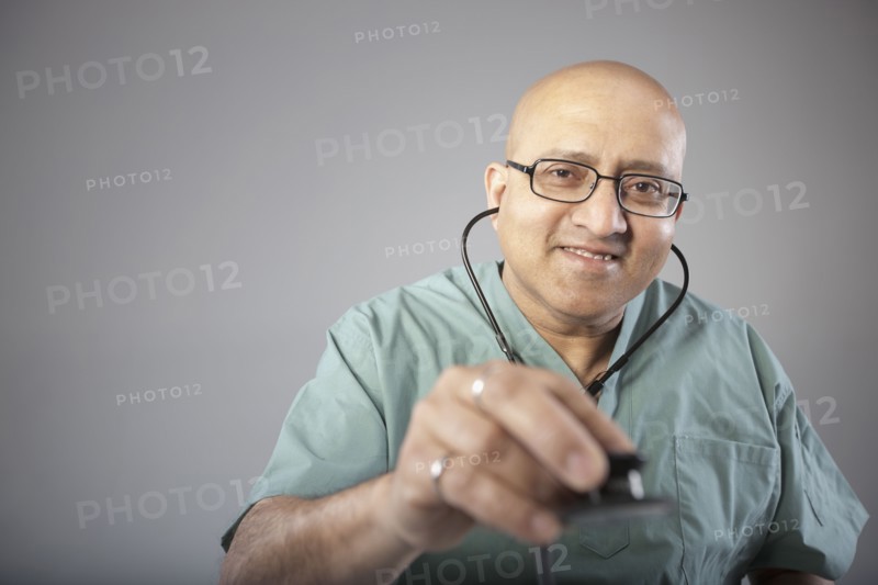 Doctor holding his stethoscope. Photo : Dan Bannister