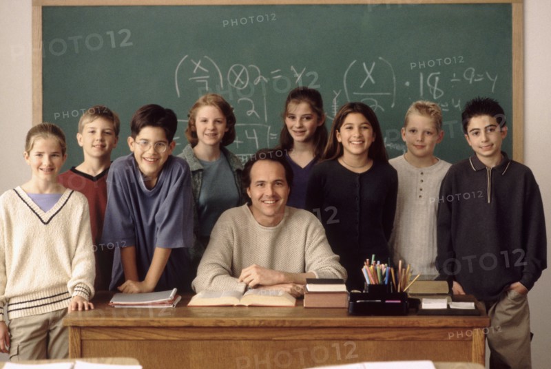 Elementary school students standing behind teacher. Photo : Rob Lewine