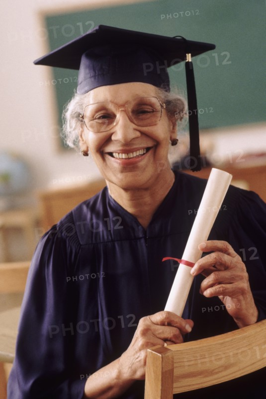 Senior student wearing graduation gown. Photo : Rob Lewine