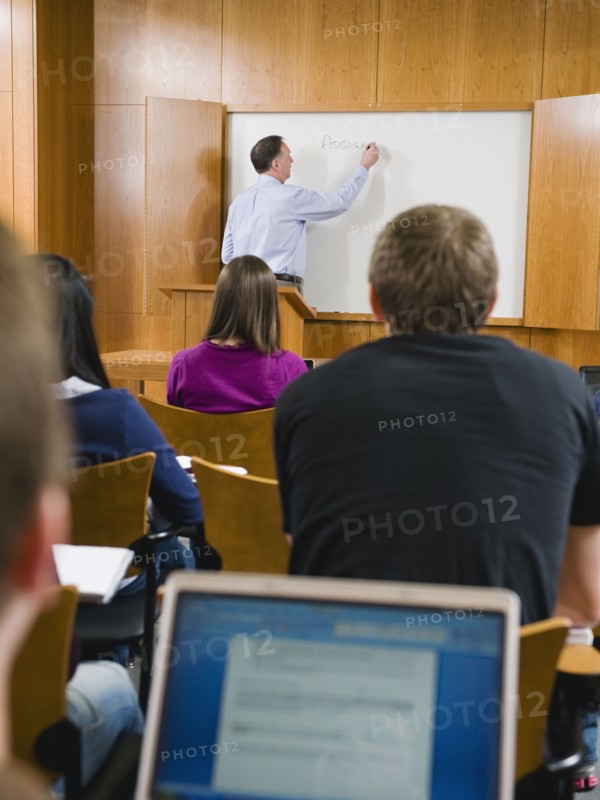 College professor giving lecture in lecture hall.