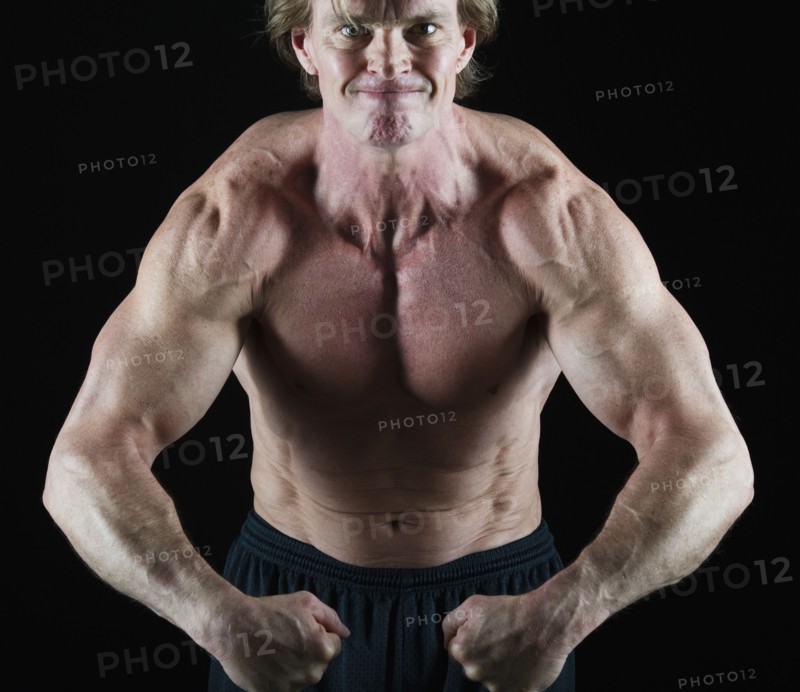 Muscular man flexing his muscles. Photo : Daniel Grill