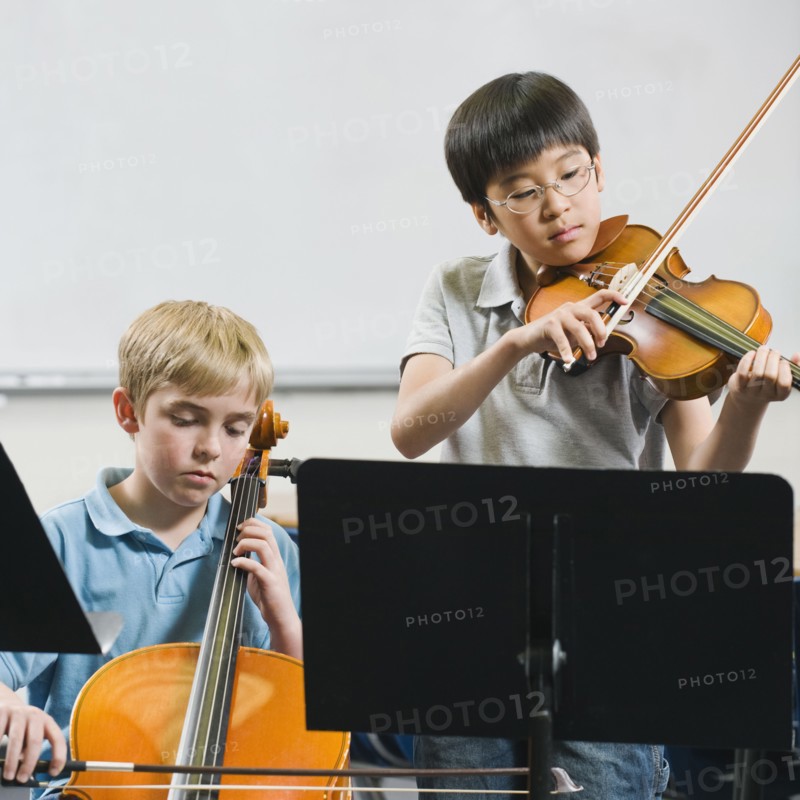 Elementary school students playing instruments in music class.