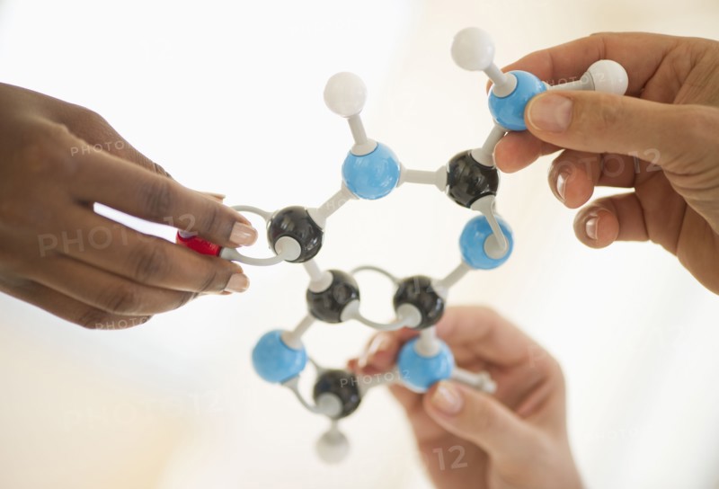 Hands holding genetic molecules.