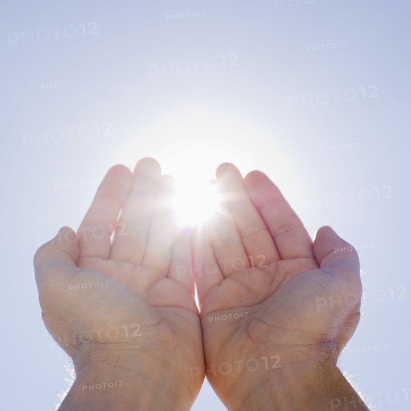 Hands framing sunshine.