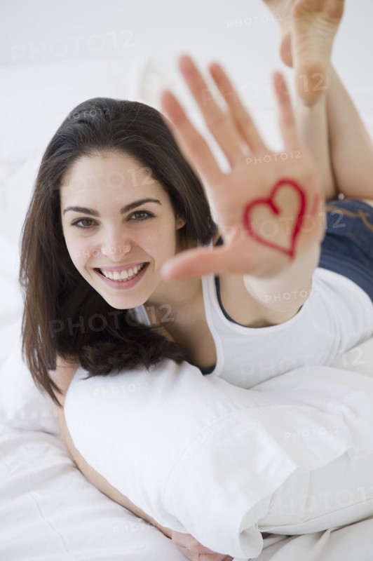 Woman with a heart drawn on her hand. Photo. Jamie Grill